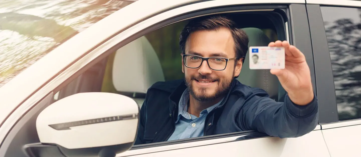 Instructor and student by car